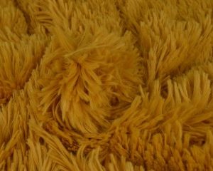 Langharig bont stof - Okergeel